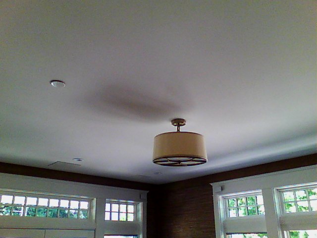 Ceiling with radiant ceiling panels installed behind the drywall to provide radiant cooling and heating.