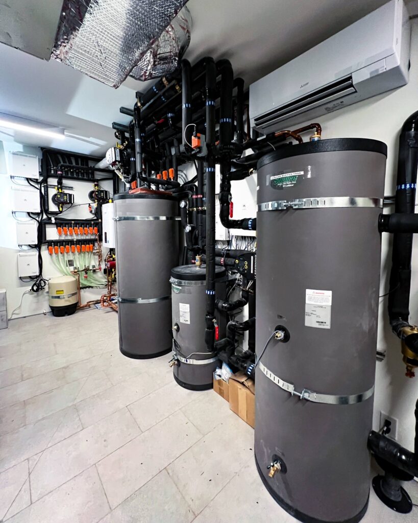 Mechanical room for a 4-pipe hydronic system that utilizes a single air-to-water heat pump to generate chilled water for hydronic cooling, while two boilers produce hot water for hydronic heating.