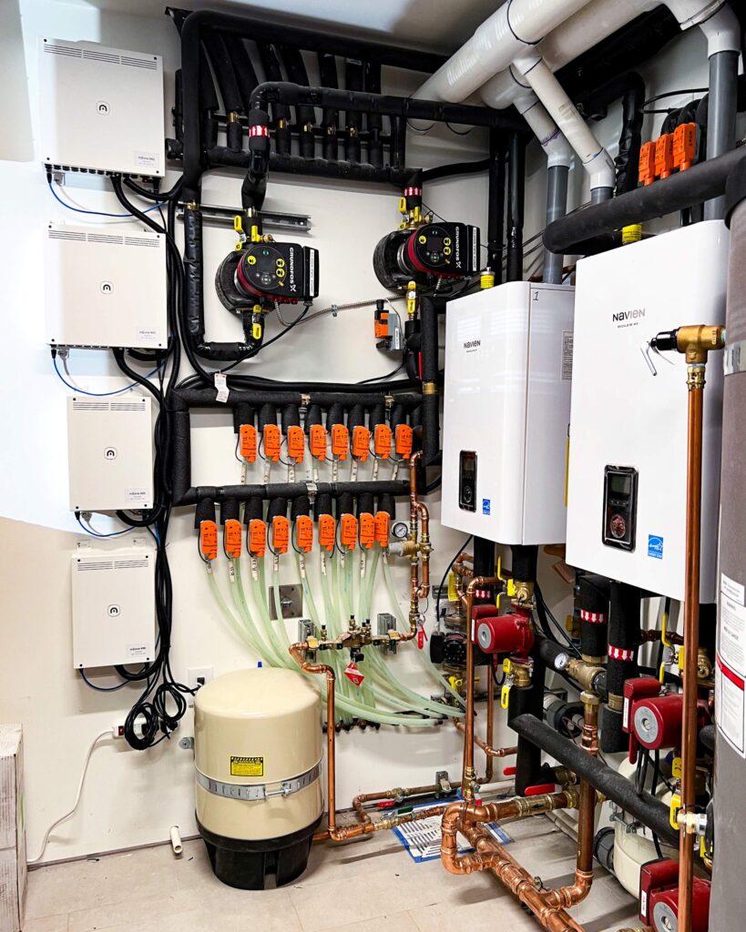 Mechanical room using Messana WHITE SERIES Controls (mBox alongside mZone zoning modules), hydronic heating and cooling is provided via a Ray Magic® radiant ceiling (H/C), radiant floor (H/C), and hydronic fan coil units (H/C) to serve 20 zones!