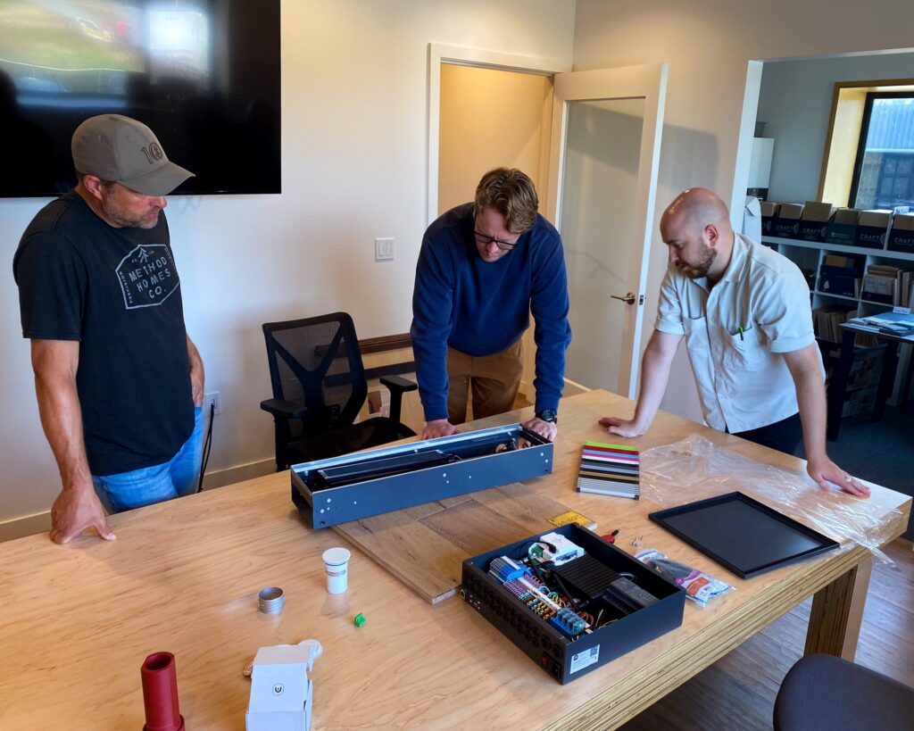 Modern Homes learning about modern hydronic solutions such as Messana mBox Hydronic Controllers, Jaga fan coil units, and Messana Ray Magic® radiant ceilings/floors.